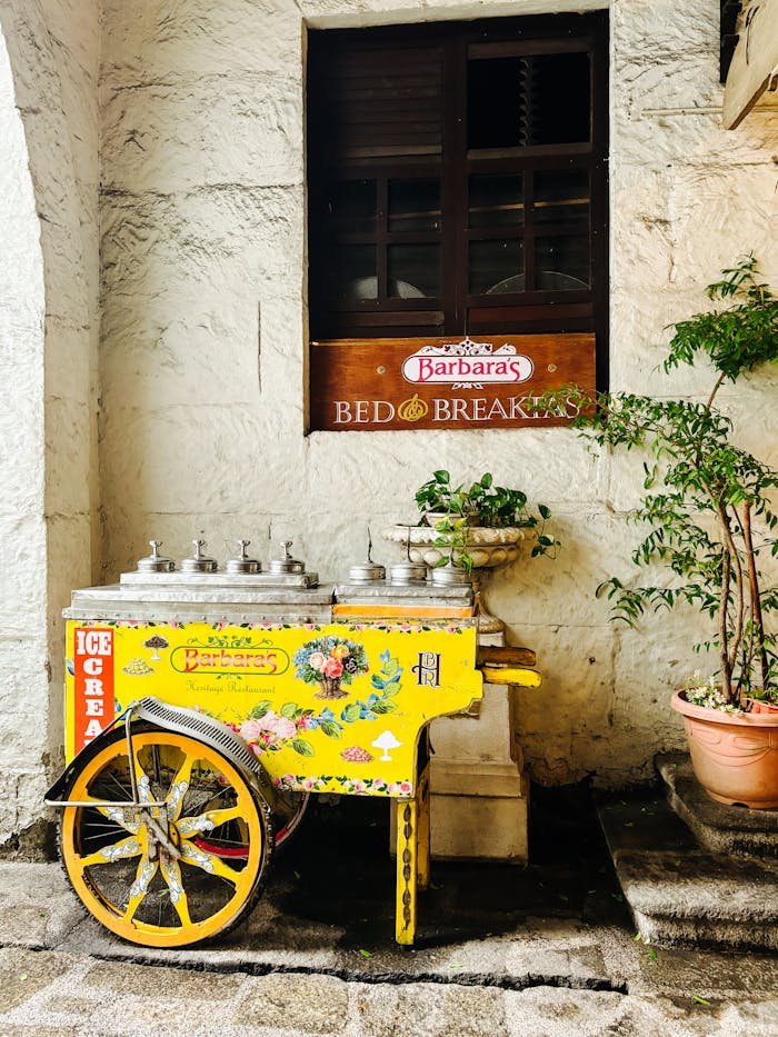 Mastering the First Impression: Your intriguing post title goes here Charming vintage ice cream cart outside Barbara's Bed & Breakfast, perfect outdoor decor.
